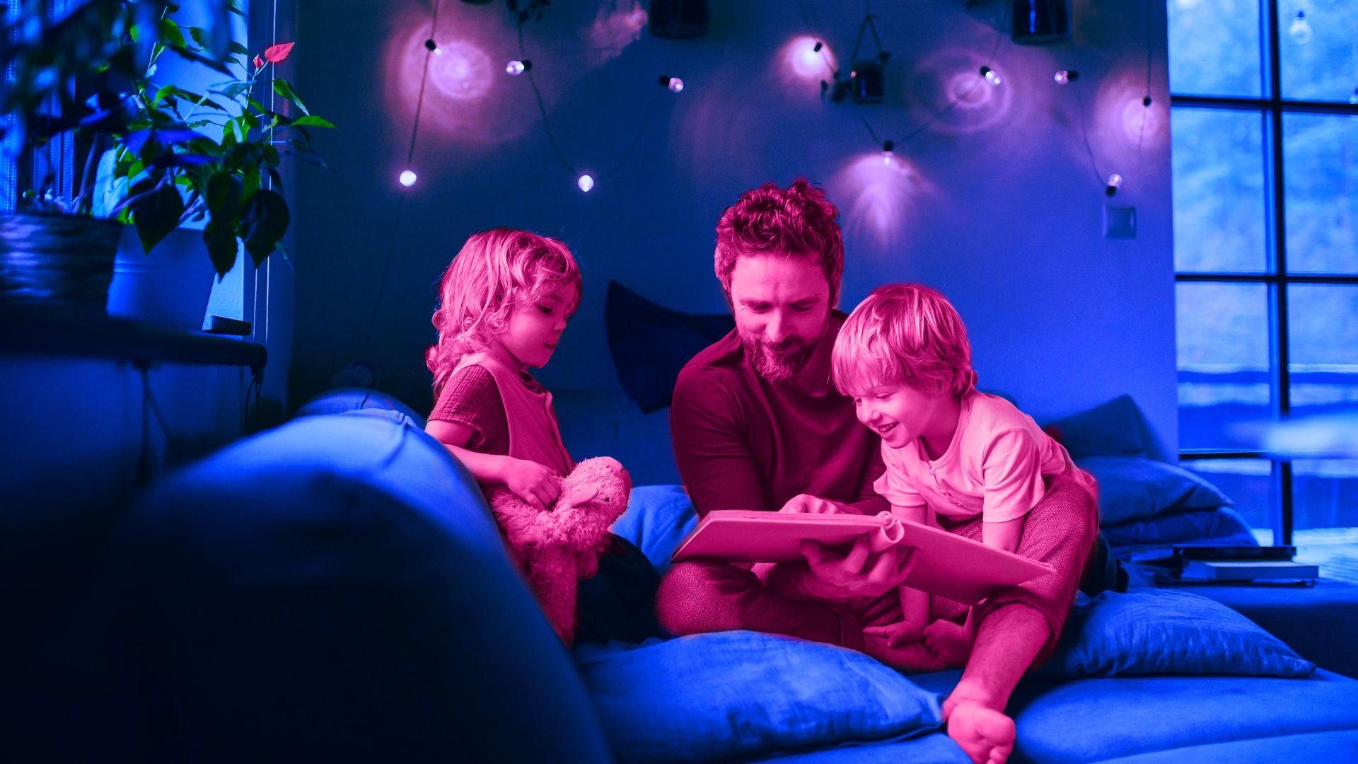 father reading stories to both of his kids
